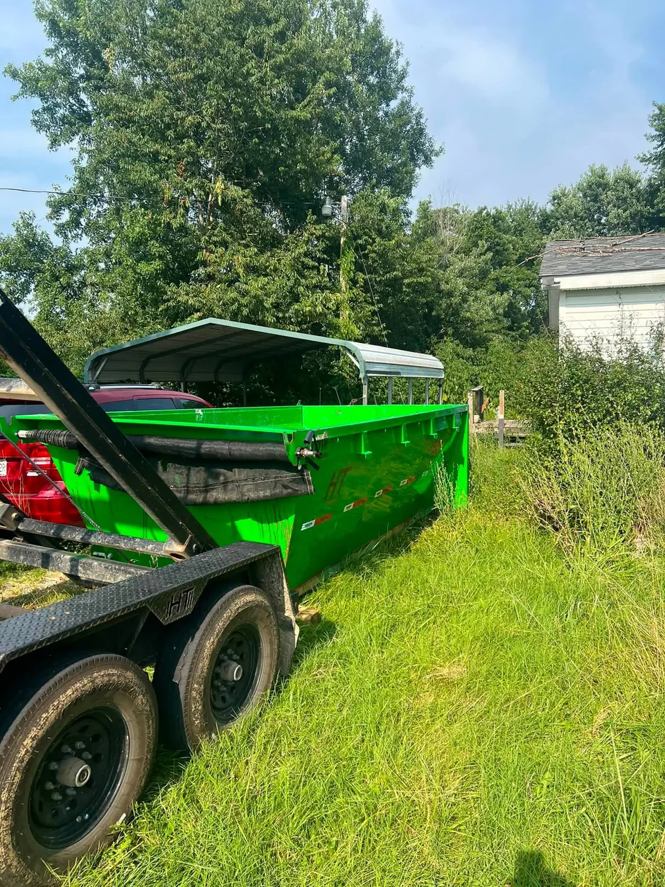 TX2 dumpster staged on a rural Franklin County lot for brush and property cleanup